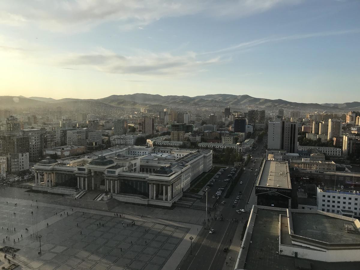 The government palace at the center of Ulaanbaatar. At the front entrance stands a statue of Ghengis Khan, respected and adored by residents. Across the street on the right and go further, you will find NUM.
