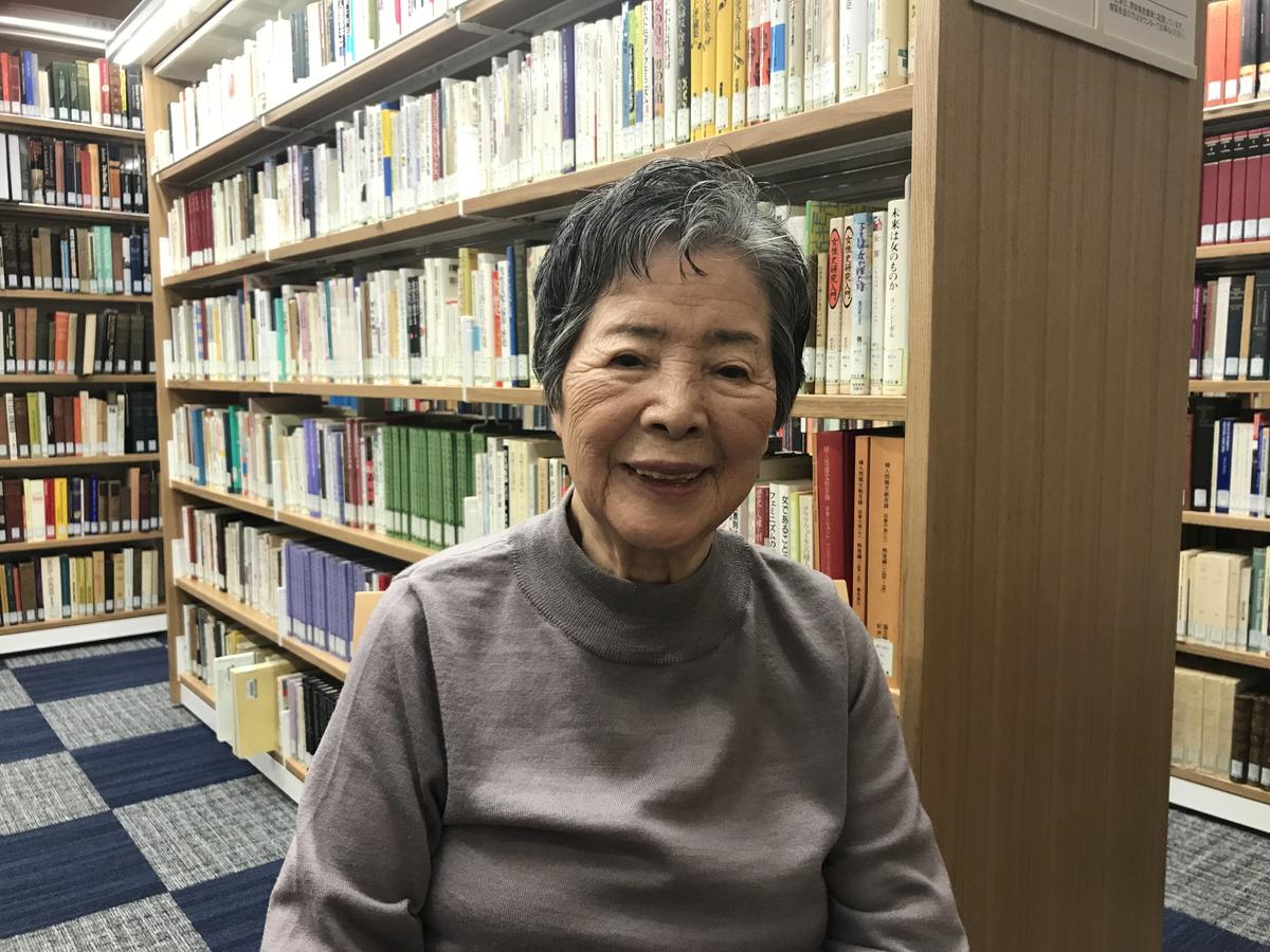 Tamae Mizuta, Professor Emeritus of Nagoya Keizai University, in front of the books at the Tamae Mizuta Library