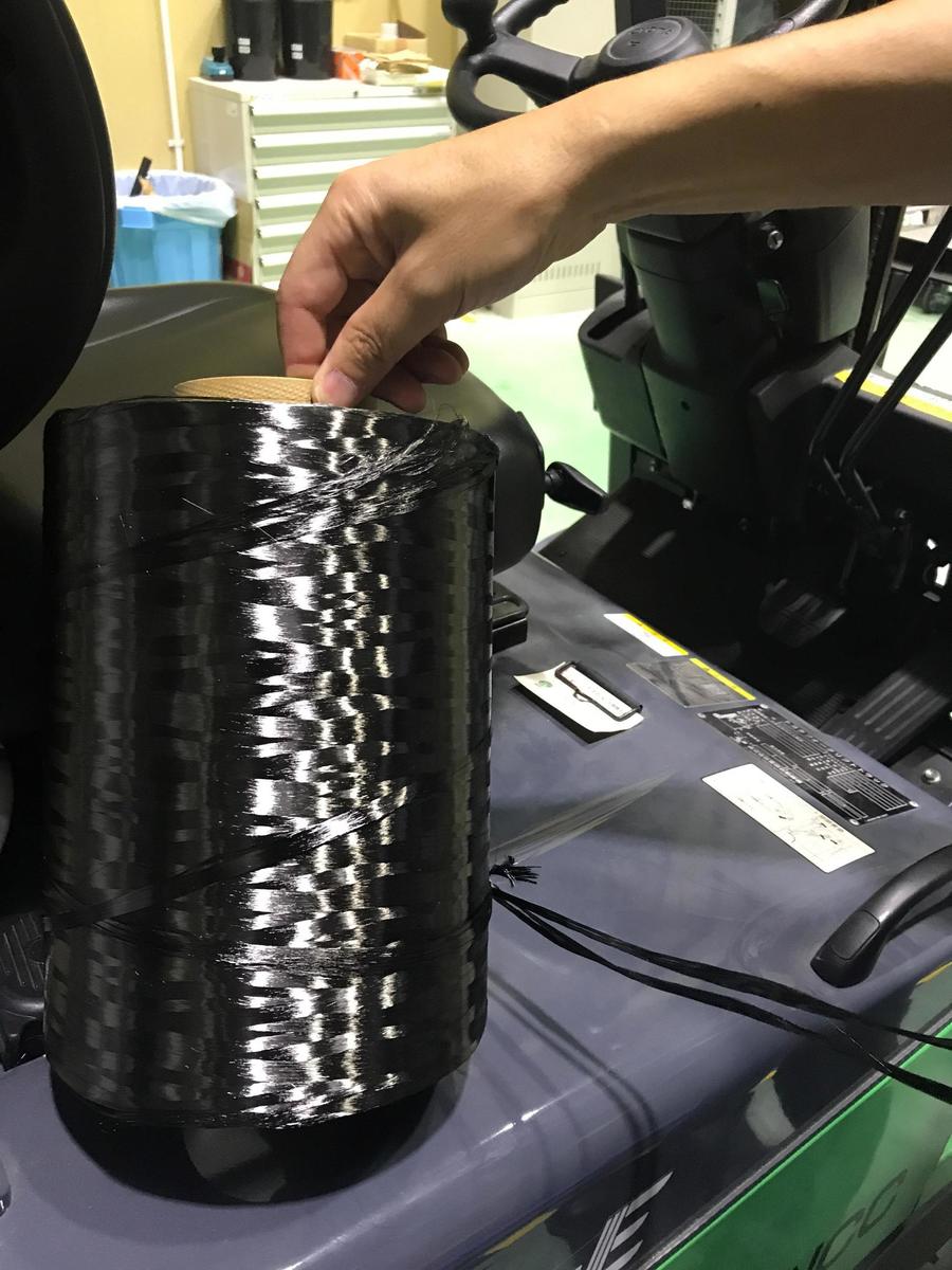 A roll of carbon fiber. A carbon fiber strand is approximately 5 microns in diameter – just a tenth of a human hair