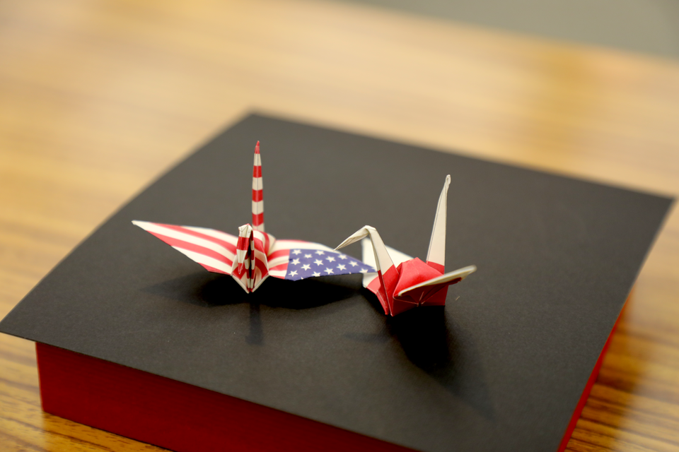 Origami cranes made from paper printed with American and Japanese flag designs