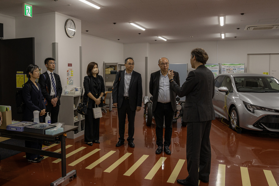 NUS representatives and staff from the Ministry of Education, Culture, Sports, Science and Technology receive a tour of Nagoya University's self-driving vehicle technology lab