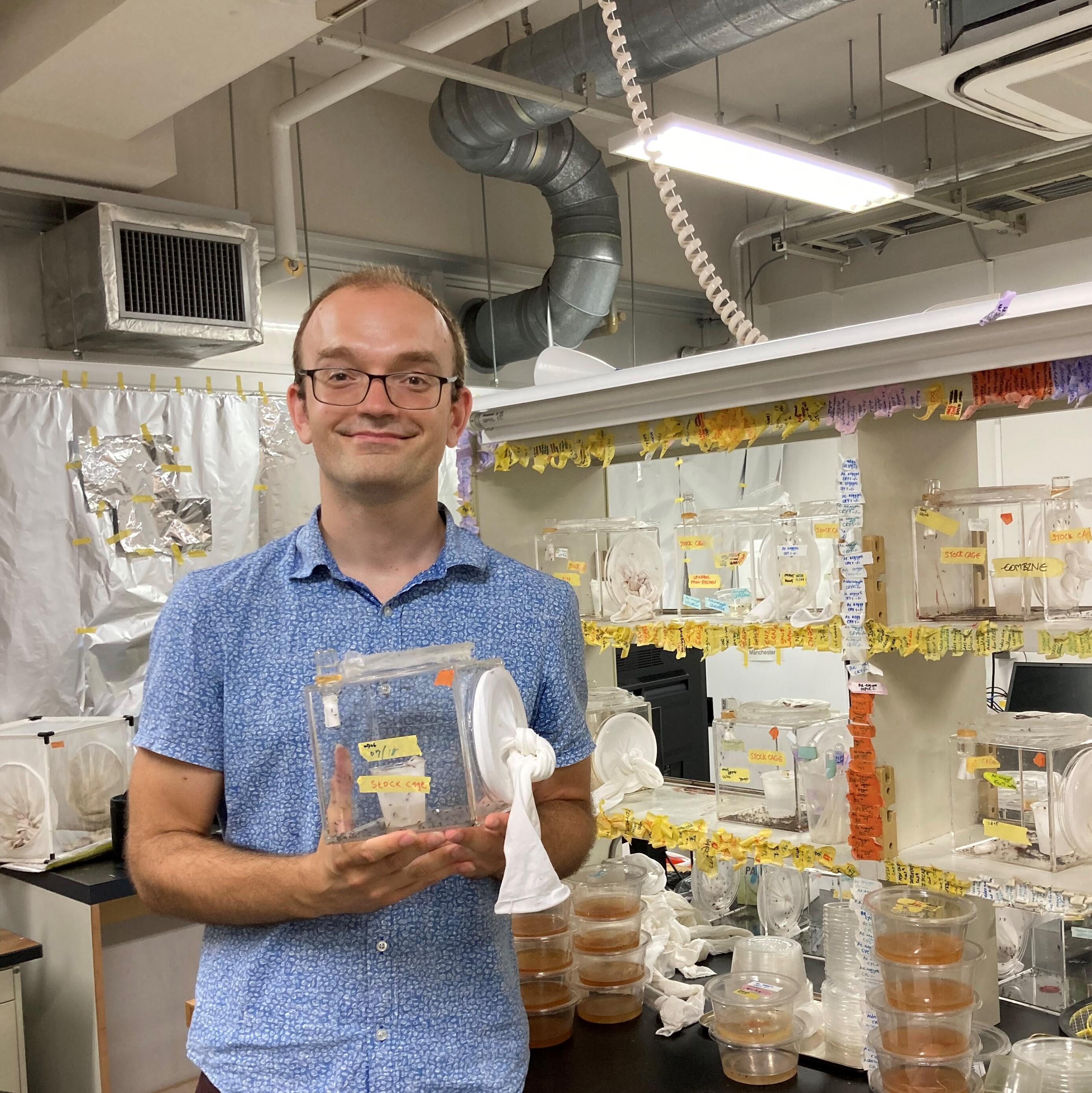 One of the corresponding authors, Matthew Su, holding a cage of mosquitoes
(Credit: International Communications Office, Nagoya University)