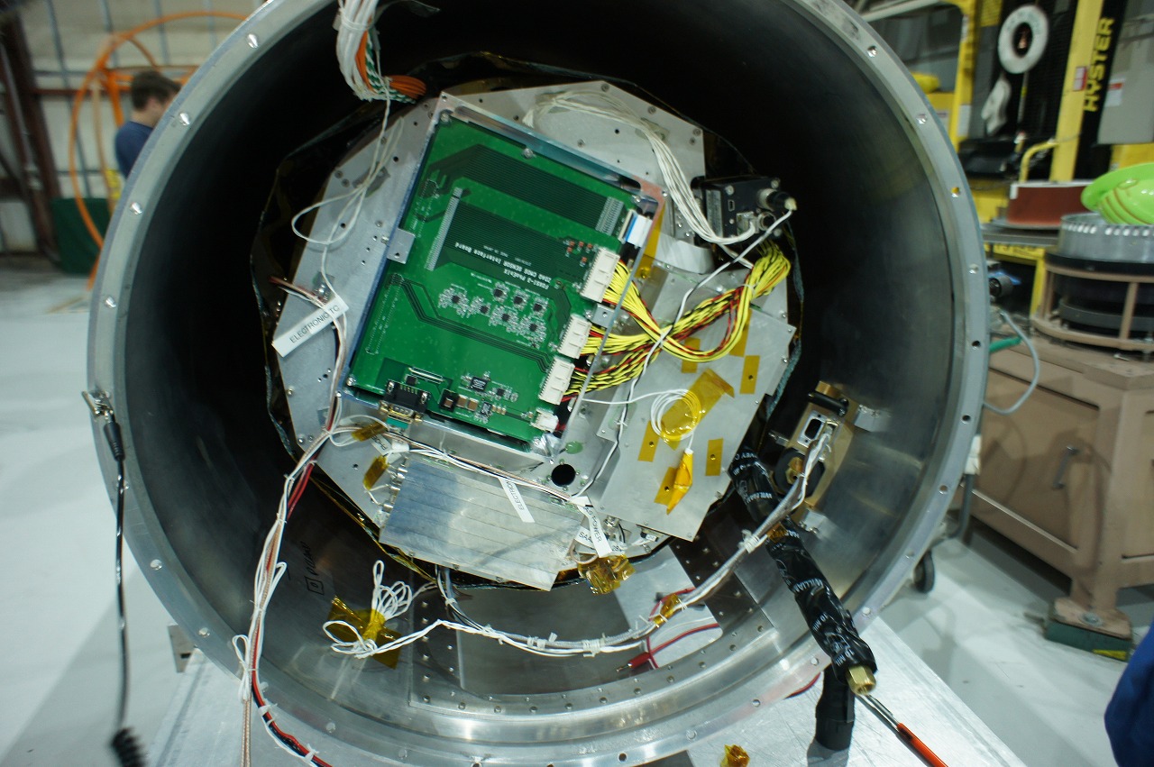 Camera electronics for the CMOS sensor. They process and store a large amount of data (about 160 MB) in one second from the CMOS sensor (green circuit board). &copy; FOXSI-3 team