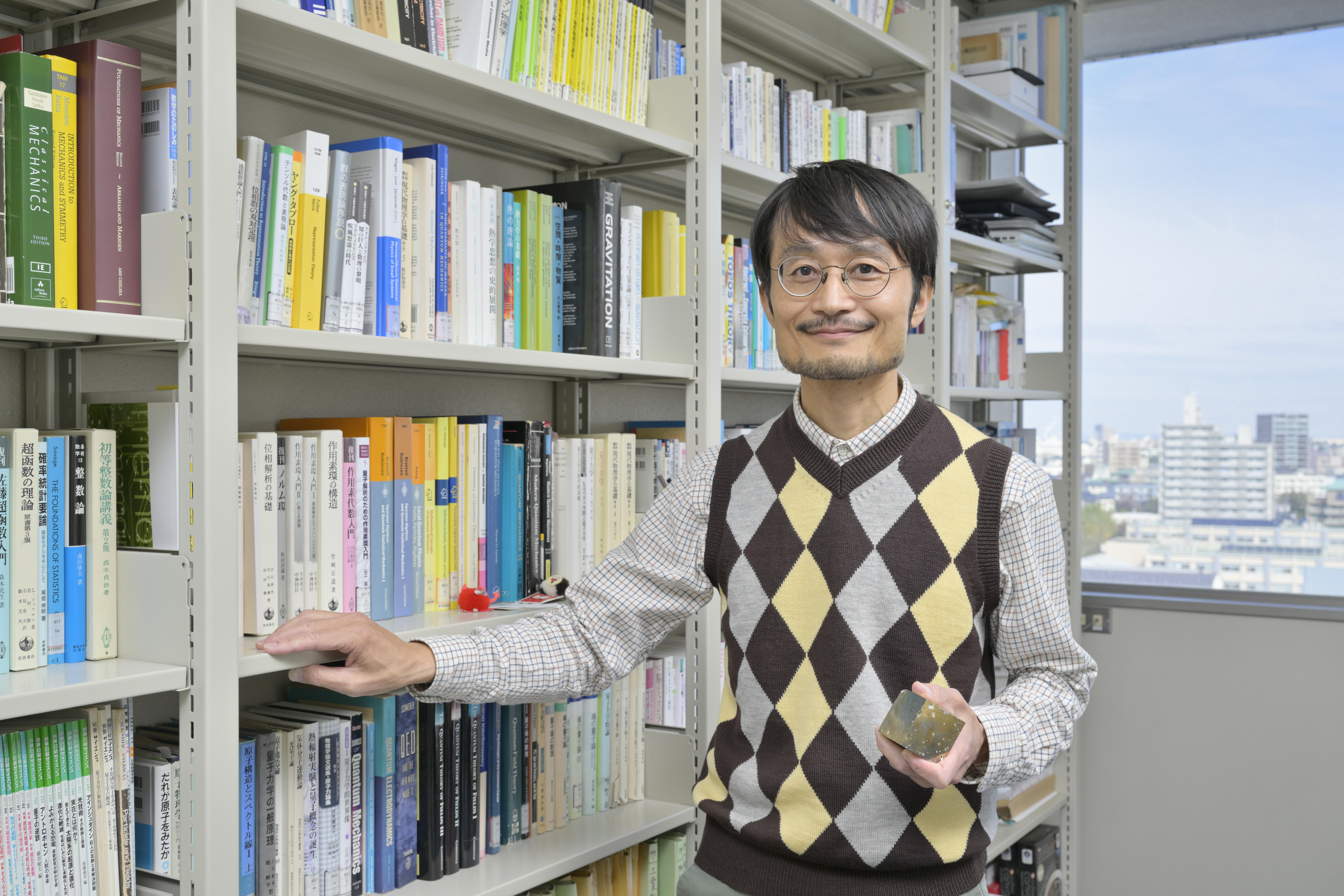 With pyrite (iron sulfide crystal) in hand