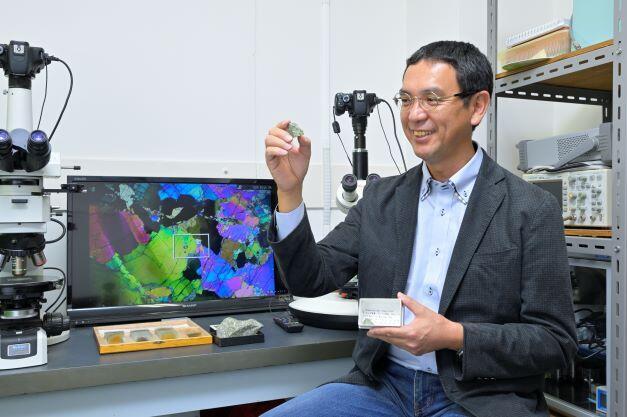 This rock is a treasured specimen of an olive-colored, mantle-derived peridotite that was recovered from 9,731 meters deep in the Tonga Trench by an American research vessel in 1996.