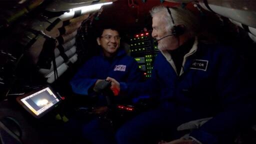 Dr. Michibayashi and world-renowned explorer Victor Vescovo shaking hands on the submersible *Limiting Factor* just after reaching the deepest point of the Izu-Ogasawara Trench, in celebration of setting the Japanese record for the deepest submarine expedition (photo courtesy of Caladan Oceanic and Inkfish)