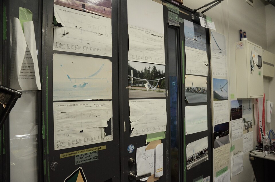 The walls are covered with blueprints and photos of past aircraft, telling the club's long history.
