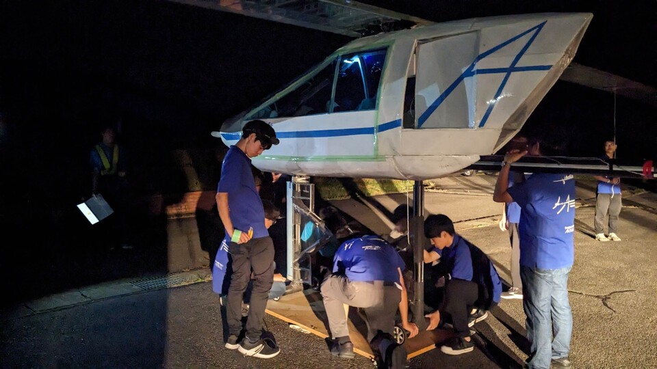 Team members working through the night before the flight.