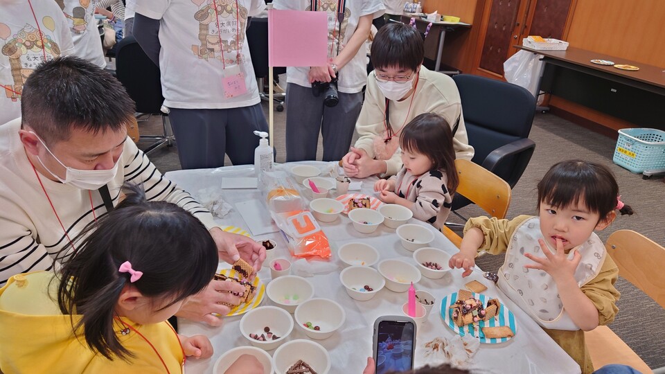 Building candy houses with their parents.
