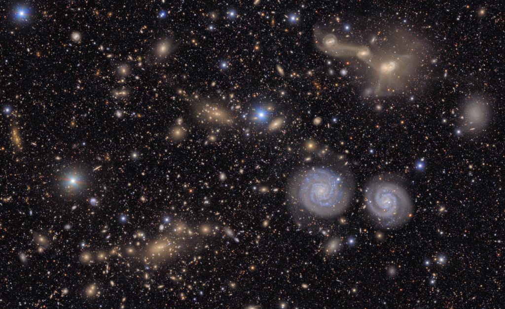 This image shows another small section of NSF-DOE Vera C. Rubin Observatory's total view of the Virgo cluster. Visible are two prominent spiral galaxies (lower right), three merging galaxies (upper right), several groups of distant galaxies, many stars in the Milky Way galaxy and more.