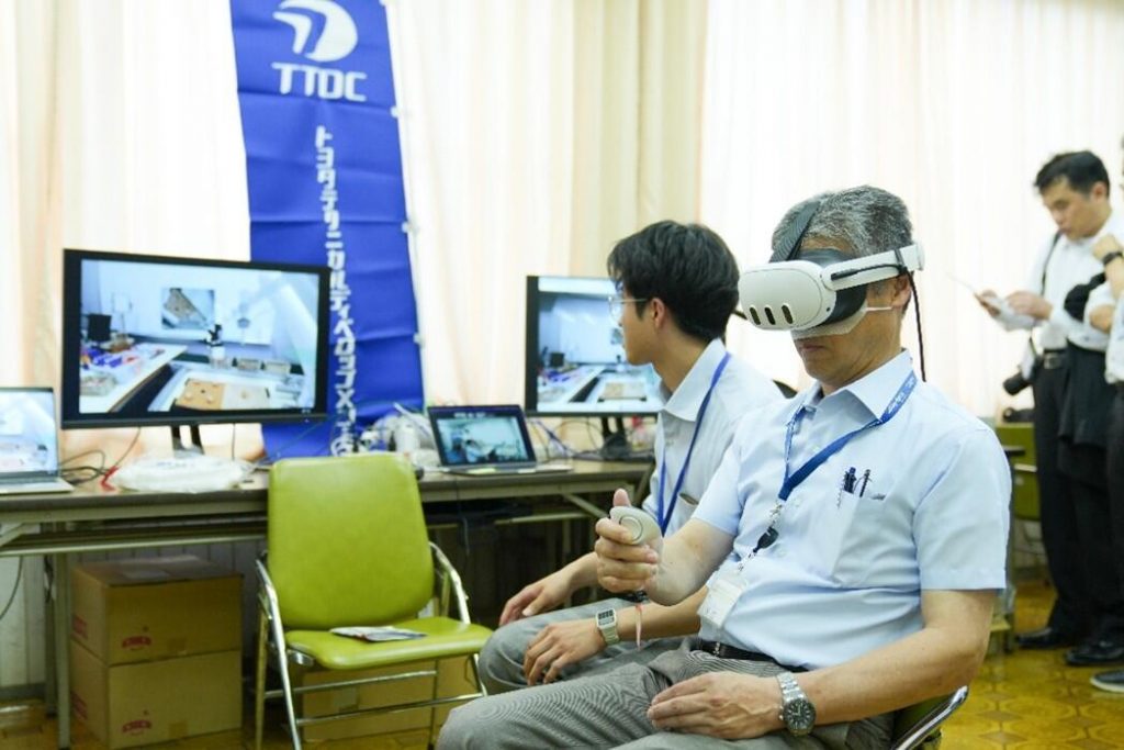 Participants operate the robotic arms using a VR headset