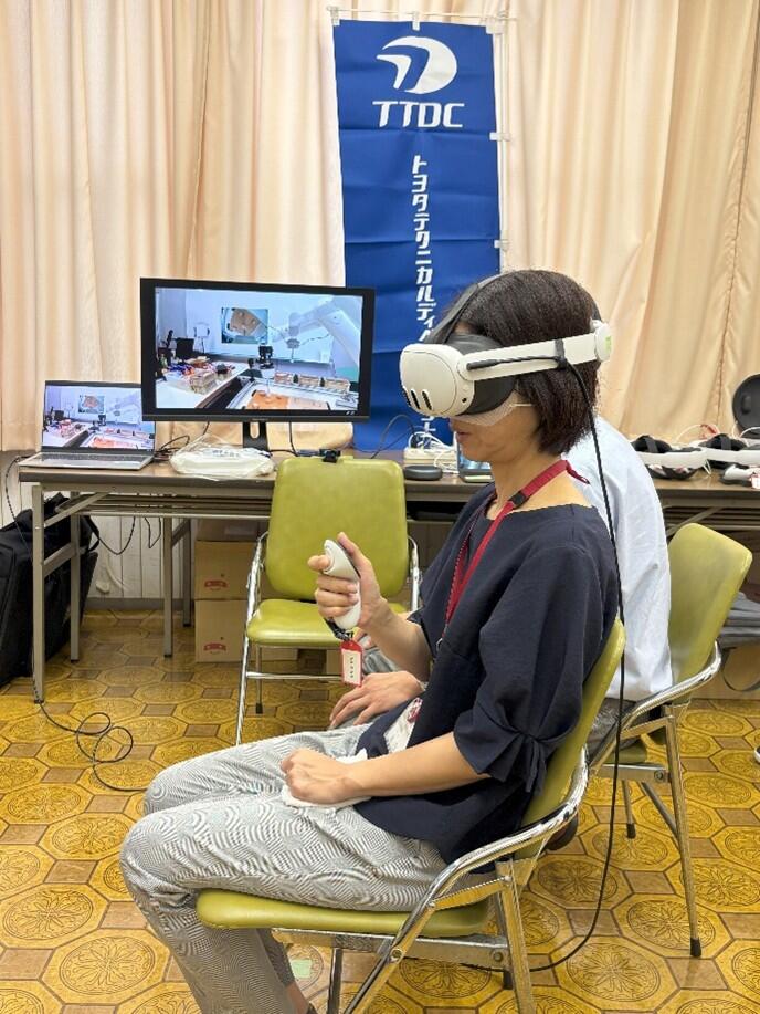 Participants operate the robotic arms using a VR headset