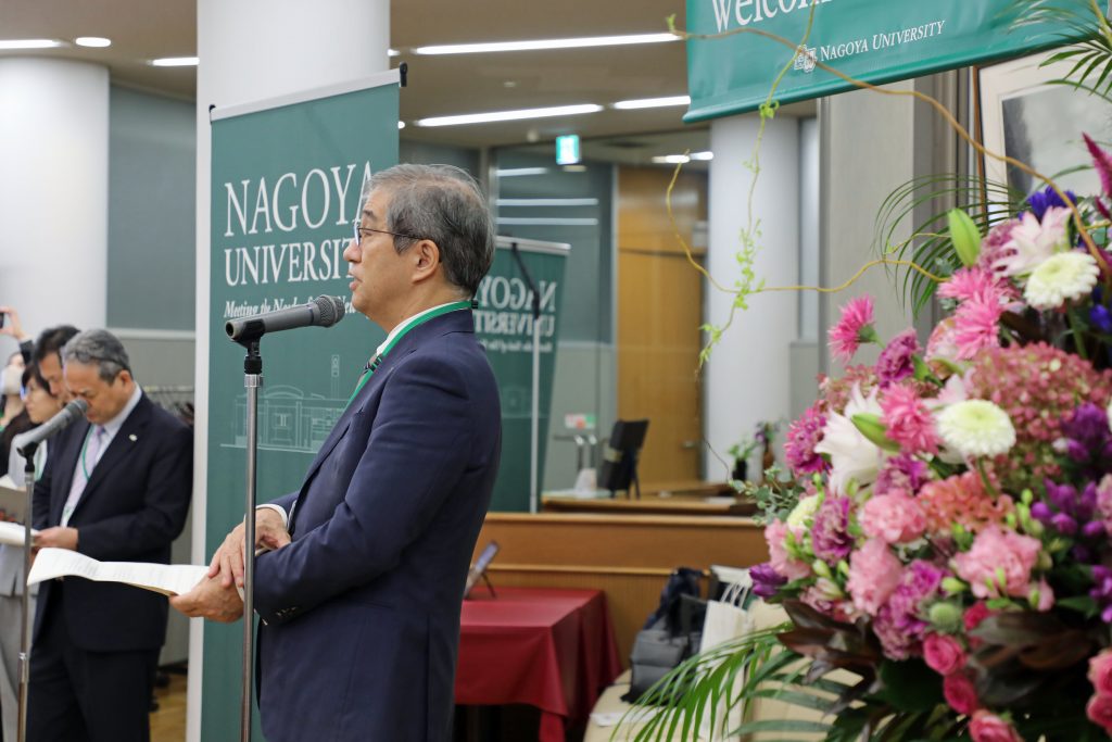 Nagoya University President Naoshi Sugiyama stands on stage and addresses the group