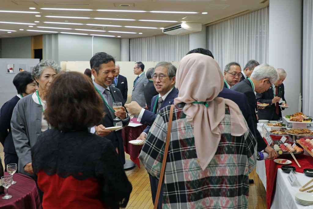 The participants gather in groups for food and drink