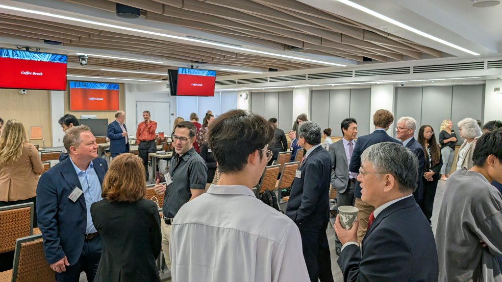 People gather to talk during a coffee break in the 40th Anniversary Symposium