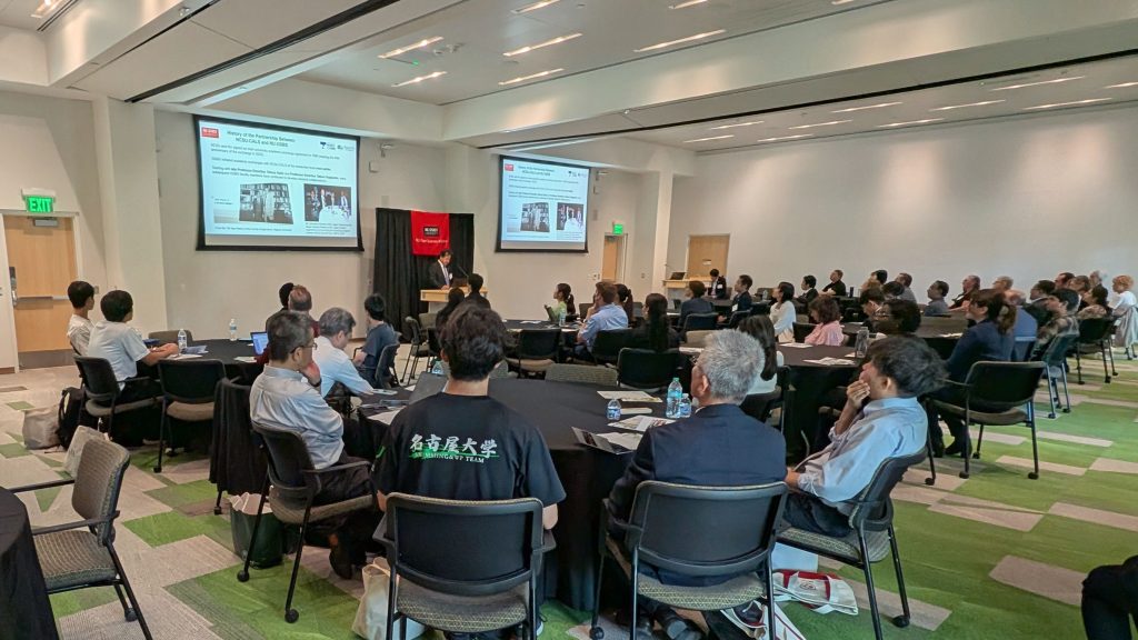 Attendees sit at round tables and listen to the NU Tech Roundtable