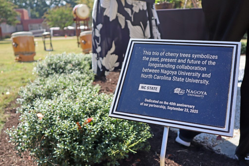 A plaque listed the details of the dedication ceremony is placed near the cherry trees