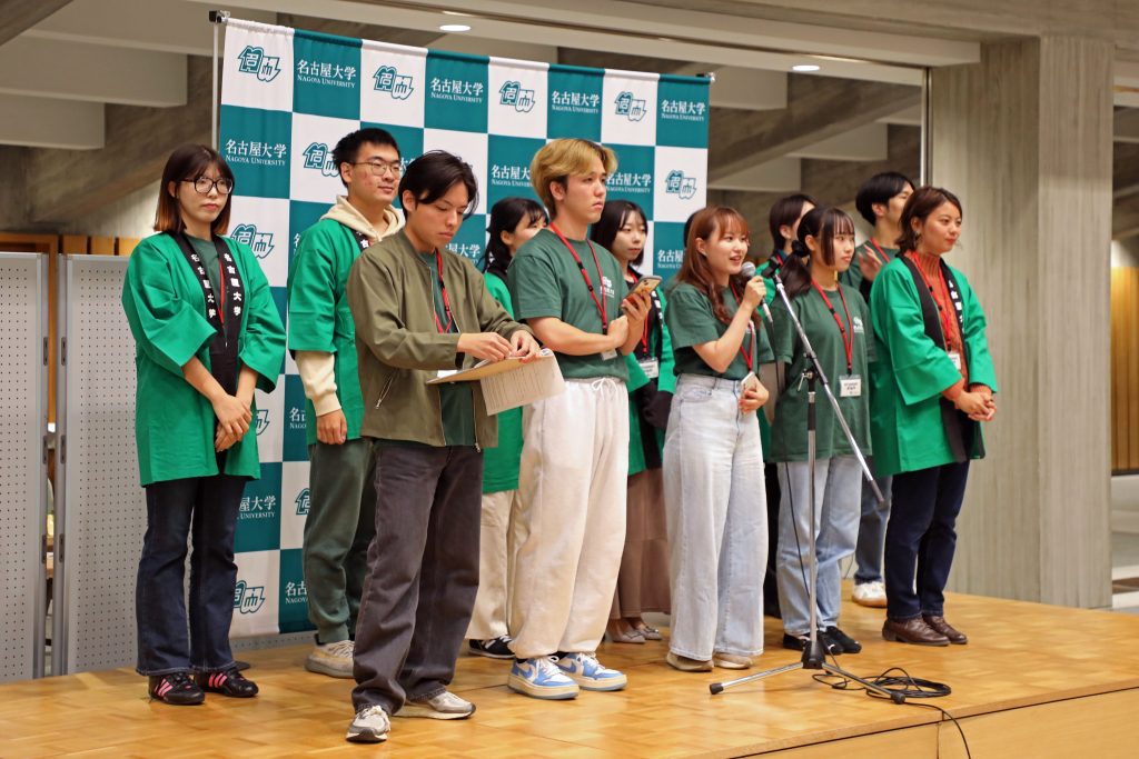 The group of student staff members stand on stage and explain the different events at the Welcome Party