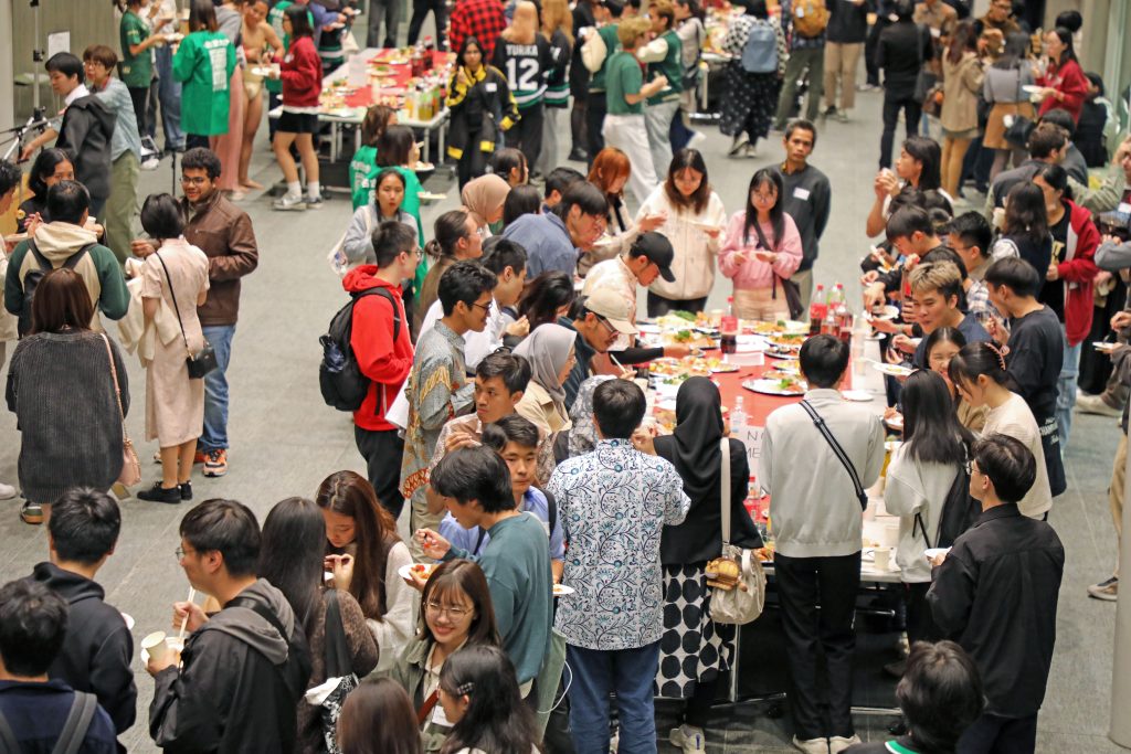 Students mingle over food and drink, introducing themselves and getting to know each other