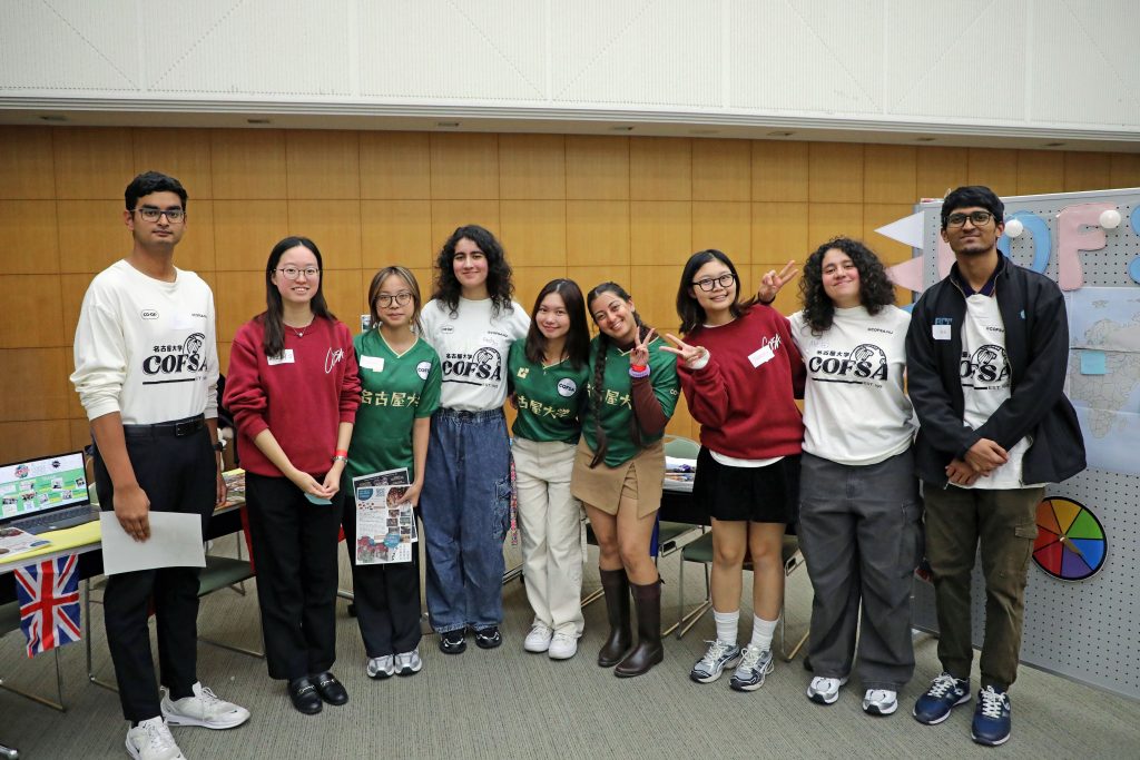 Some representatives of the Nagoya University Co-op Foreign Student Association pose for a photo at their booth