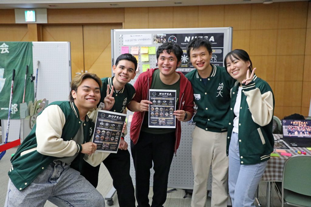 Students from the Nagoya University International Student Association (NUFSA) hold of flyers advertising their group