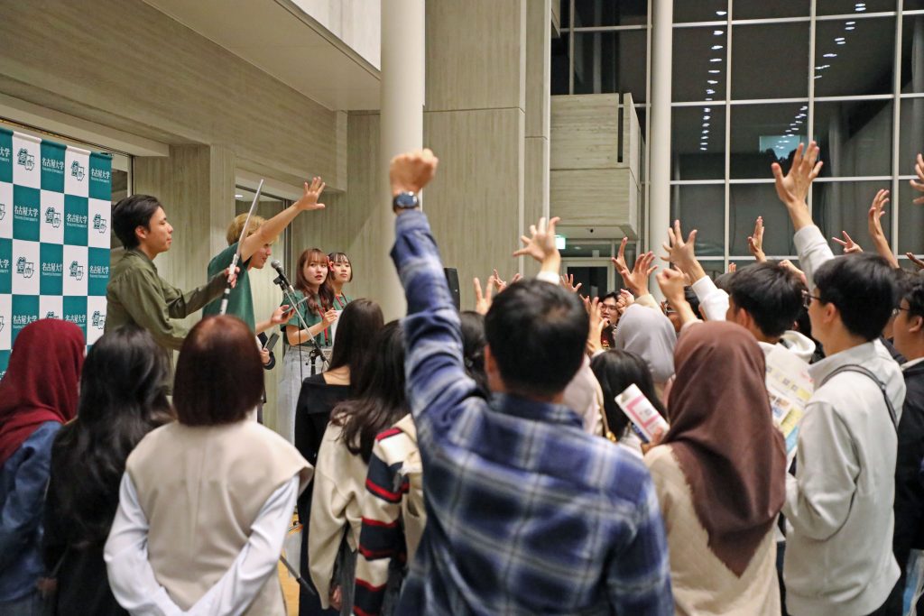 Students gather around the stage for the the rock-papers-scissors competition 