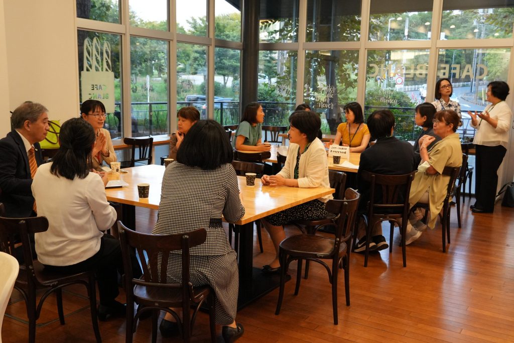 Participants at the 2025 Leading Women Researchers Award reception sit at tables and talk