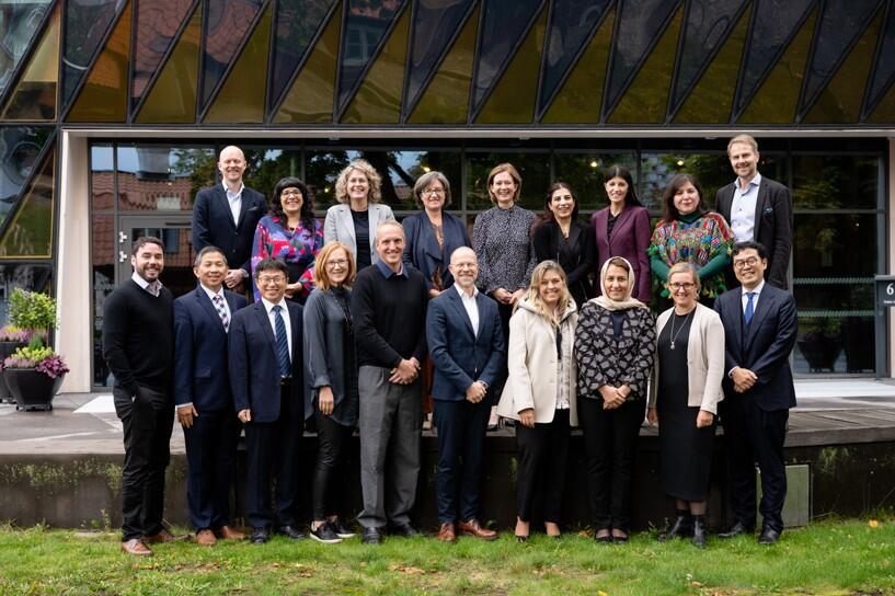 Participants from the workshop held in October stand in two rows for a group photograph.