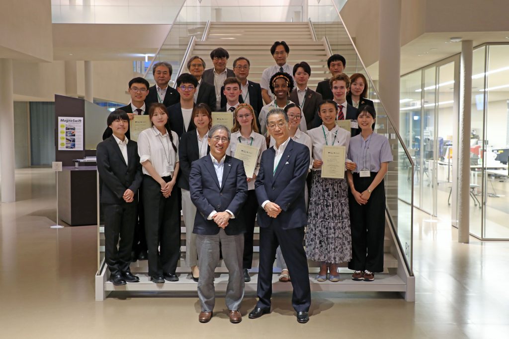 Students from Nagoya University and St John's College stand on stairs in Common Nexus with leadership from Nagoya University and Tokai Tokyo Financial Holdings.
