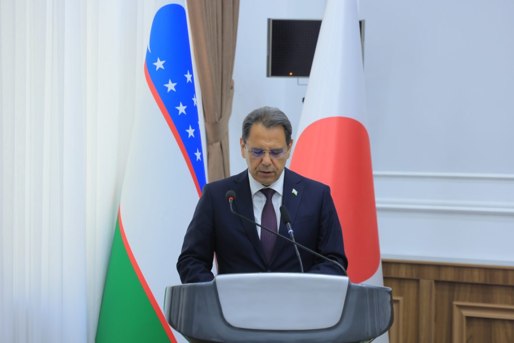 Kongratbay Sharipov, Uzbekistan’s Minister of Education, Science and Innovation, stands at a podium and gives his welcoming remarks.
