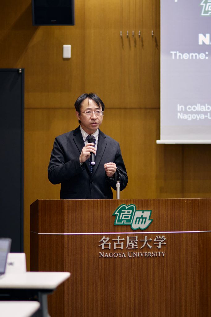 Professor Tanikawa speaking at podium