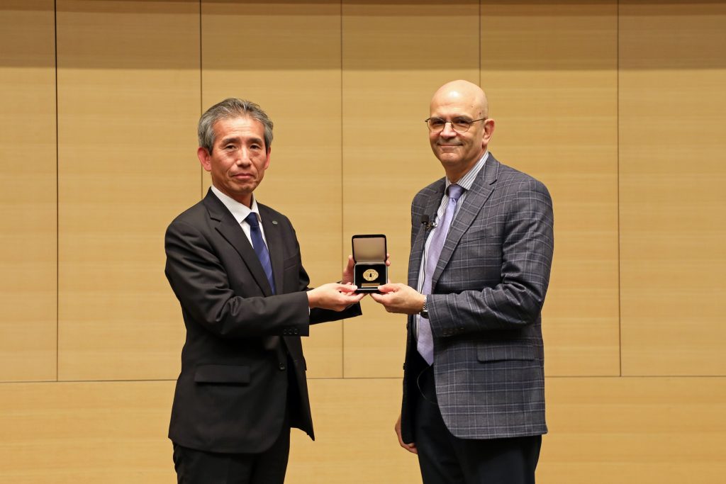 Professor Erick M. Carreira of ETH Zurich receives his medal on stage.