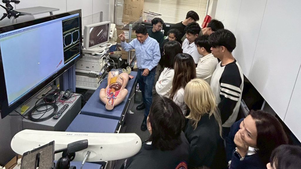 Students tour a laboratory researching the medical applications of robotics.