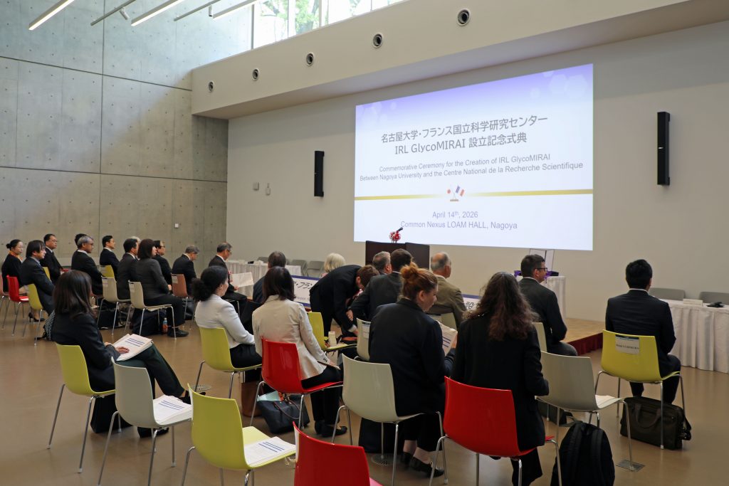 Attendees sit it rows of rows in the room prior to the start of the ceremony.