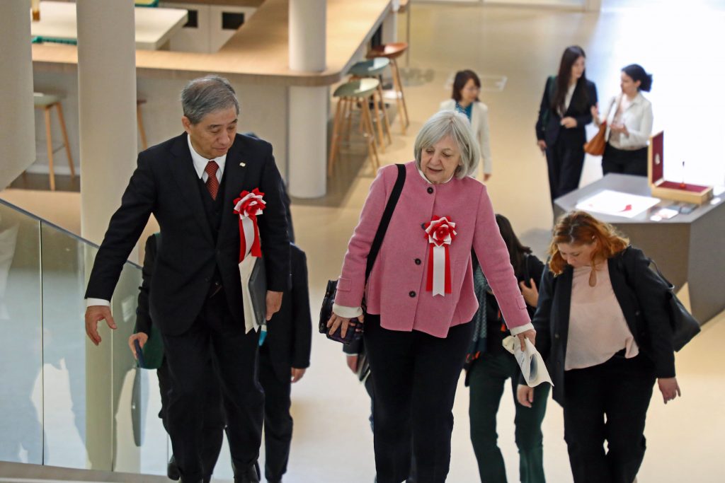 Naoshi Sugiyama and Béatrice Le Fraper du Hellen walk up stairs in Common Nexus.