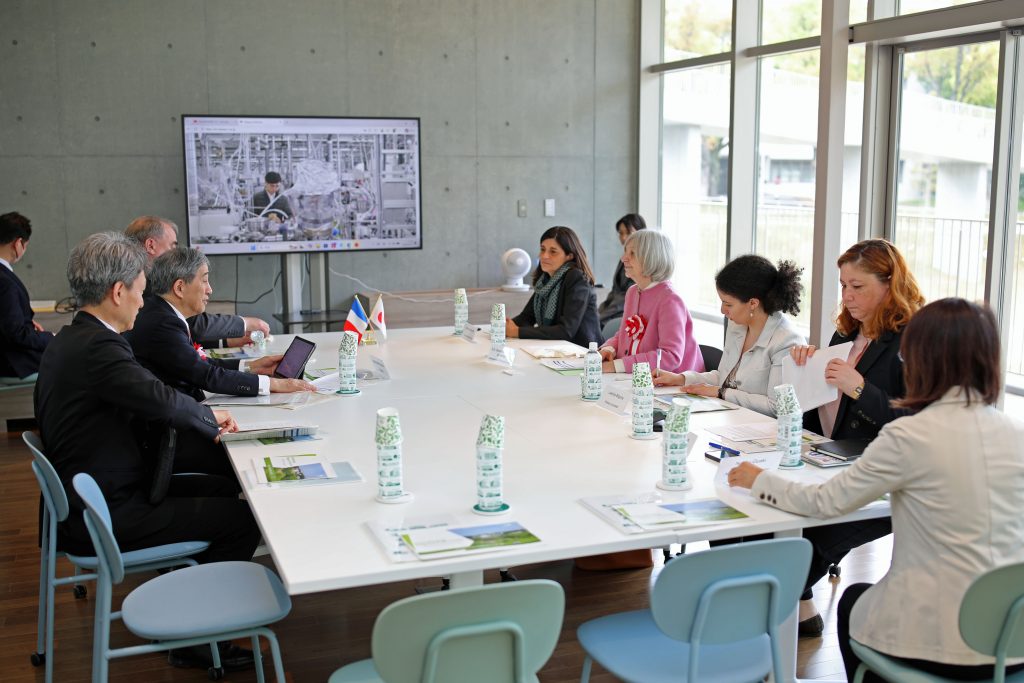 Participants of the meeting sit at a table in Common Nexus.