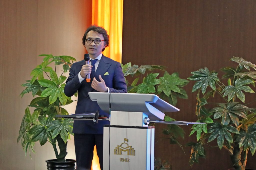 Ganbayar Batbayar speaks from a podium on stage.