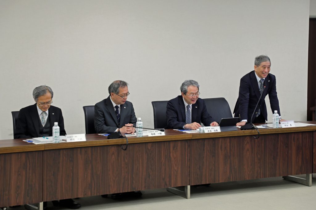 Nagoya University President Naoshi Sugiyama stands to give his opening remarks.