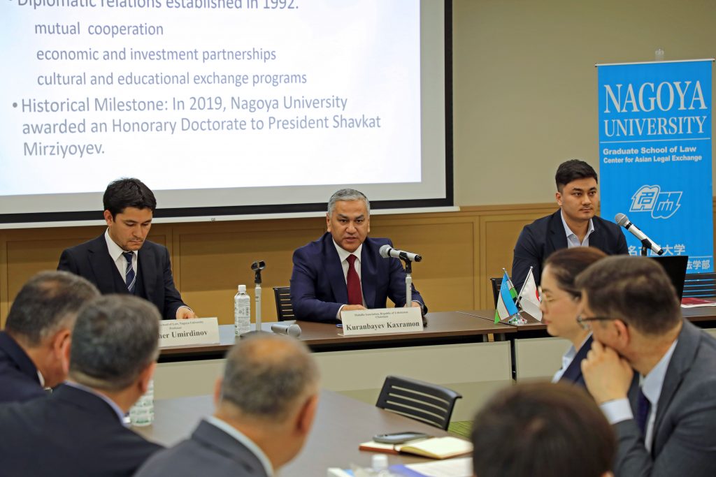 Kakhramon Kuranbaev sits at a table while giving his remarks.