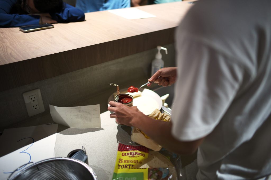 Student prepares canned tomato