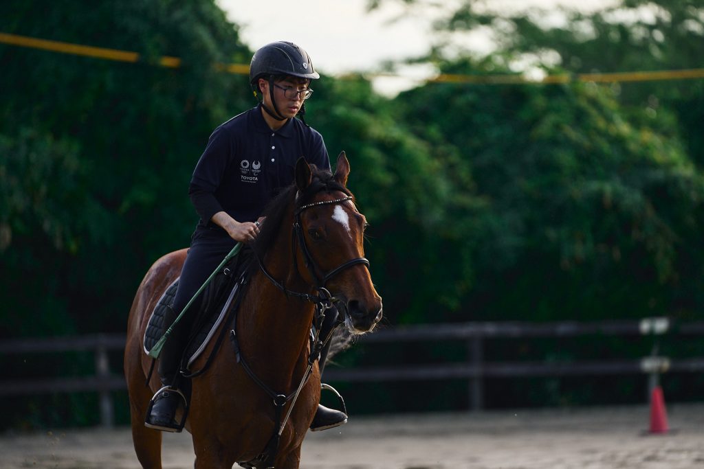 Close up of student warming up a club horse