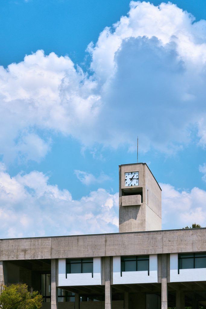 The Toyoda Auditorium under blue sky and clouds